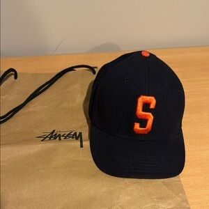 Stussy Navy Blue SnapBack Hat with Vibrant Orange Lettering